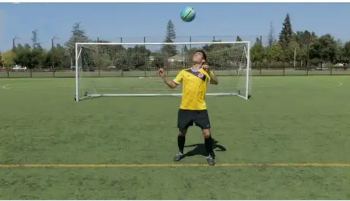 Top 10 football exercises to improve on dribbling, image showing juggling.